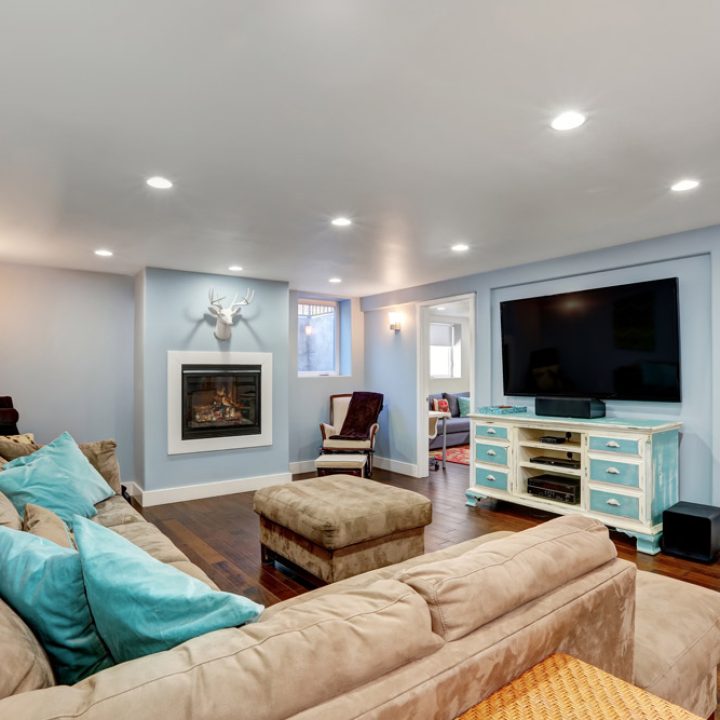 basement living room with pastel blue walls